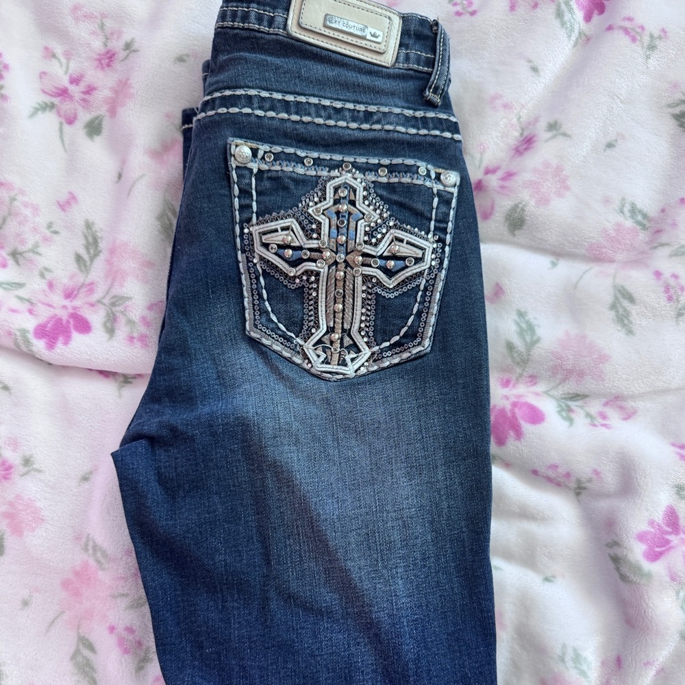 Blue Jeans with Rhinestone Cross Design and White Stitching